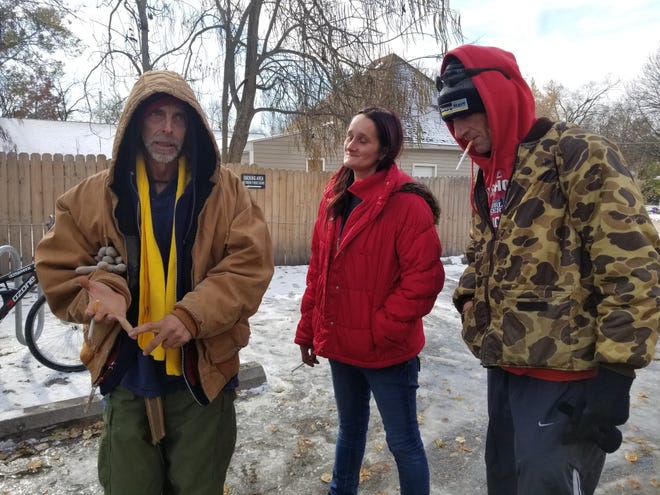 Leon Lambeth, left, talks about the challenges of being homeless in freezing weather Wednesday, with his wife, Debra Lambeth, and Danny Hutcheson, outside Wilkes Boulevard United Methodist Church. The church houses Turning Point, a day shelter open from 8 a.m. to noon each day. [Rudi Keller/Tribune]