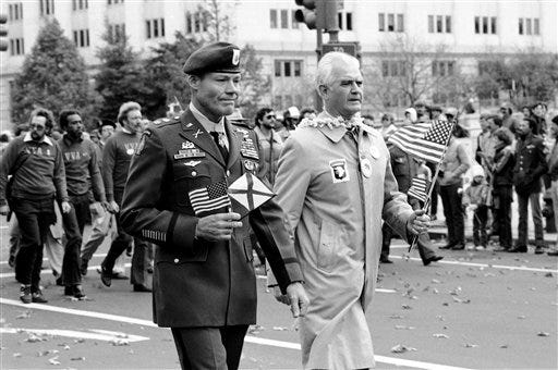 Ret. Gen. William Westmoreland, right, former commander of forces in Vietnam marches alongside Robert Howard of Opelika, Ala., wearing his medal of honor around his neck, during the Vietnam Veterans parade Nov. 13, 1982, in Washington. [Barry Thummma/The Associated Press]
