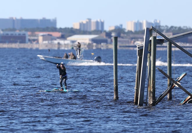 Participants compete in Paddle 4 PC in January 2018 in St.Andrews. Participants of all skill levels paddled about a mile through St. Andrew Bay. Living near water has positive health benefits, according to a new study. [PATTI BLAKE/NEWS HERALD FILE]