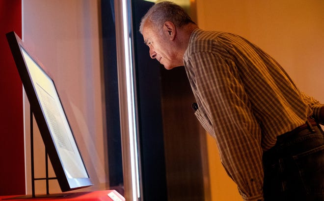 In this file photo, Frank Cordoba of San Diego, California, gazes at a handwritten copy of the Gettysburg Address on display at the Abraham Lincoln Presidential Museum in November 2018. The document is on display again at the museum through Dec. 2. [Ted Schurter/The State Journal-Register file photo]