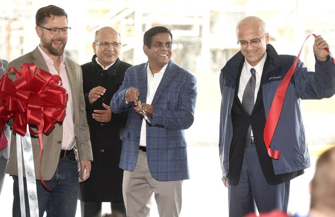 Manus Bio CEO Ajikumar Parayil (middle, holding scissors) cuts the ribbon at the company's Augusta production facility, accompanied by board members Byron Alsberg (from left) and Michael Carlos along with MIT professor Gregory Stephanopoulos. [MICHAEL HOLAHAN/THE AUGUSTA CHRONICLE]