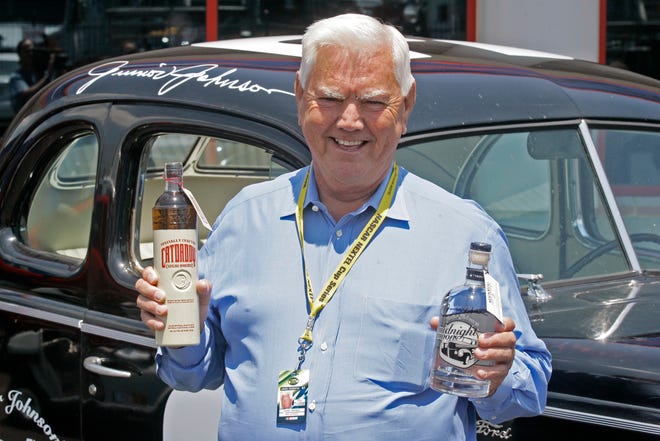 Junior Johnson, shown here promoting his legal “moonshine” in 2007, has long been part of NASCAR’s off-and-on relationship with liquor. [AP File]