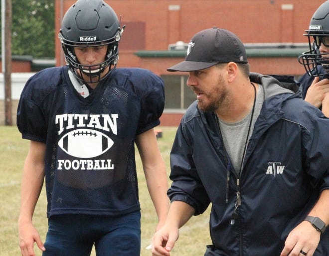 Coltin Quagliano, left, receives instruction from Annawan-Wethersfield coach Logan Willits during a preseason practice on Aug. 17 on the campus of Wethersfield High School. [Troy E. Taylor]