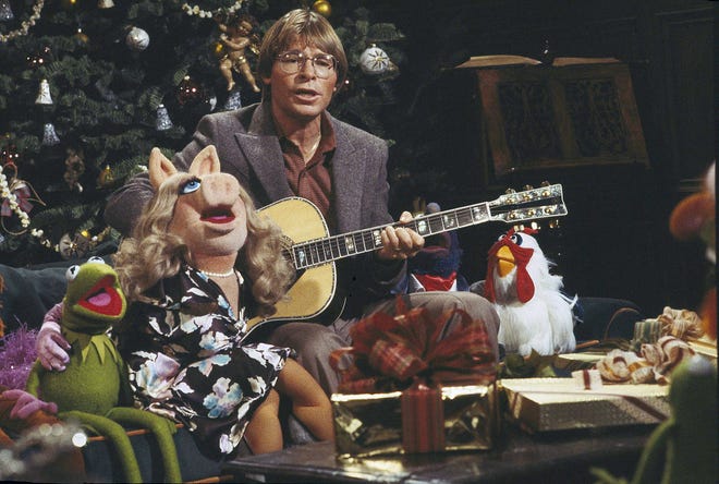 Singer John Denver, with children, aged 6-10, at a taping session Nov. 15, 1979 for his upcoming holiday television special, "John Denver and the Muppets, A Christmas Together."  The show will be broadcast on ABC-TV, Dec. 5, 1979, 8-9 pm.  Denver told the yuletide story of "Silent Night" to his small guests, and they are joined by Kermit the Frog, Miss Piggy, Fozzie Bear, and all the famed Jim Henson Muppets in sing the the traditional carol. (AP Photo)