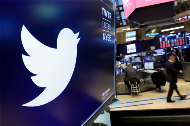 FILE - In this Feb. 8, 2018 file photo, the logo for Twitter is displayed above a trading post on the floor of the New York Stock Exchange. In a policy published Friday, Nov. 15, 2019 Twitter said it is banning ads that contain references to political content, including appeals for votes, solicitations of financial support and advocacy for or against political content. The ban also includes any ads by candidates, political parties, elected or appointed government officials. (AP Photo/Richard Drew, File)