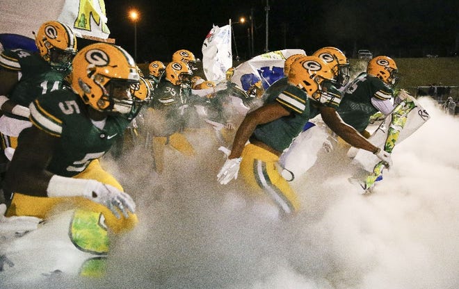 Gordo players take the field through a cloud of smoke before its game with Bullock County in the first round of the Class 3A football playoffs last week. The Greenwave hosts Providence Christian tonight in the second round. [Staff Photo/Gary Cosby Jr.]