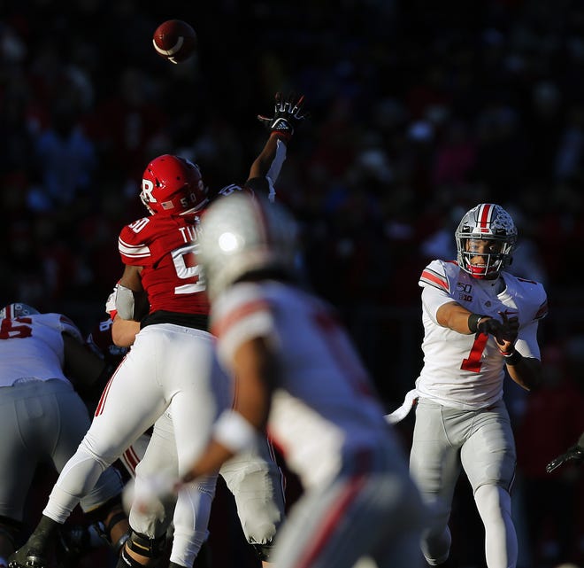 Ohio State Buckeyes quarterback Justin Fields (1) throws the ball to Ohio State Buckeyes wide receiver Chris Olave (17) against Rutgers Scarlet Knights during the 1st quarter of their game at SHI Stadium in Piscataway, N.J on November 16, 2019. [Kyle Robertson/Dispatch]