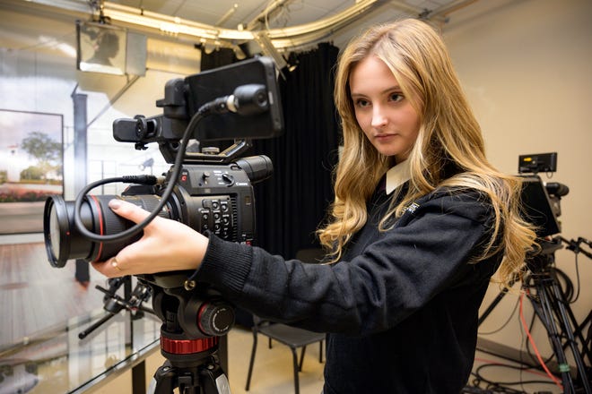 Molly Smith adjusts her camera on set at Montverde Academy. Smith won a student Emmy for Best PSA for “Dear America” and for Writing in a reel she composed highlighting her previous work. [Cindy Sharp/Correspondent]