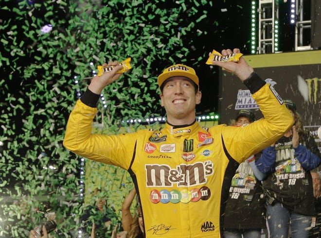 Kyle Busch celebrates in Victory Lane after winning Sunday’s NASCAR Cup Series auto racing season championship in Homestead. [AP Photo/Terry Renna]