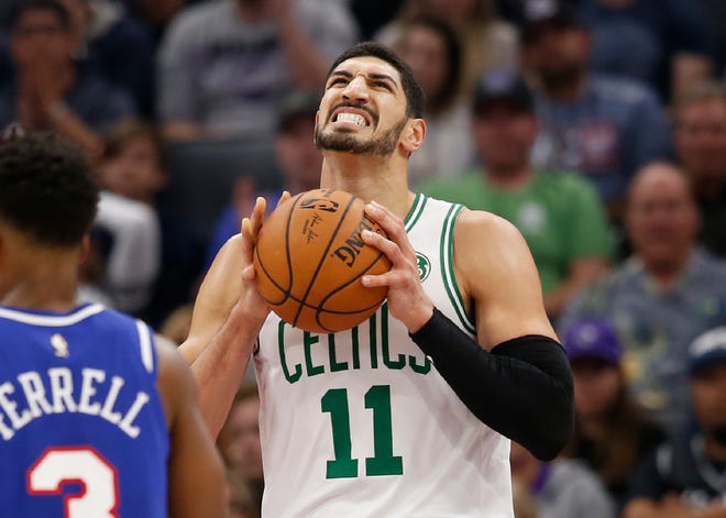 Boston Celtics center Enes Kanter, right, reacts after a foul was called against his team during the second half Sunday against the Sacramento Kings in Sacramento, Calif. [RICH PEDRONCELLI/THE ASSOCIATED PRESS]