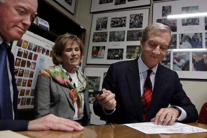 Democratic presidential candidate businessman Tom Steyer files to be placed on the New Hampshire primary ballot at the Statehouse on Tuesday in Concord, N.H. Watching, middle, is Steyer's wife, Kat Taylor, and, far left, is Secretary of State Bill Gardner. [ELISE AMENDOLA/THE ASSOCIATED PRESS]