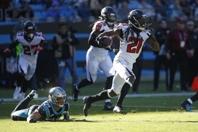 Atlanta cornerback Desmond Trufant (21) runs while Panthers running back Christian McCaffrey (22) misses the tackle during the first half in Charlotte, N.C. on Sunday. [BRIAN BLANCO/THE ASSOCIATED PRESS]