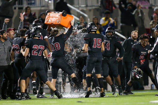 Weiss players douse their football coach, Thomas Aultman, with ice after beating Lockhart in a Class 5A DII playoff win over Lockhart Friday at The Pfield. [LOURDES M SHOAF for Statesman.]