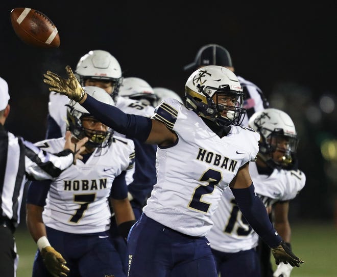 Hoban's Devin Hightower (right) celebrates after recovering a Mayfield fumble during the first quarter of a Division II regional semifinal football game, Friday, Nov. 15, 2019, in Macedonia, Ohio. [Jeff Lange/Beacon Journal]