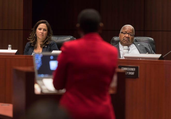 City Commissioner Christina Lambert, left, and Mayor Keith James listen to interim City Administrator Faye Johnson recommending Monday that the city settle with Sharagay Esposito for $180,000. Commissioners rejected the recommendation. [GREG LOVETT/palmbeachpost.com]