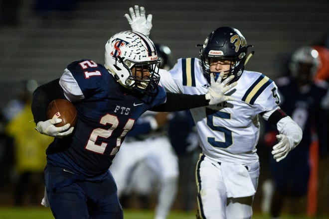 Terry Sanford running back Dorian Clark (21) finished with a season-high 41 carries and 291 yards with four touchdowns in the Bulldogs 49-20 win against Wilson Fike on Thursday in the first round of the NCHSAA 3-A state playoffs. [Andrew Craft/The Fayetteville Observer]