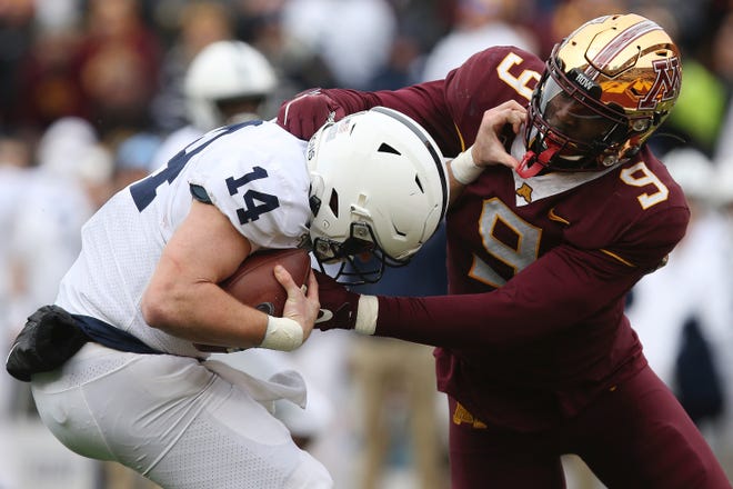 Penn State quarterback Sean Clifford is sacked by Minnesota defensive lineman Esezi Otomewo during the Lions’ 31-26 loss on Nov. 9. [STACY BENGS / ASSOCIATED PRESS]
