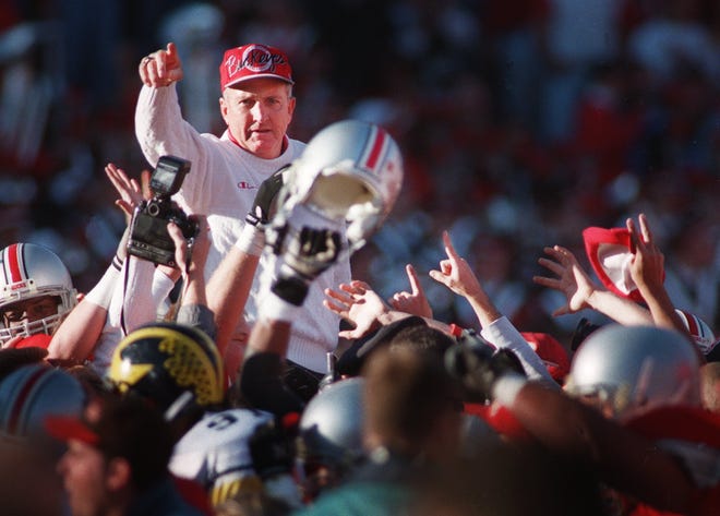 Ohio State coach John Cooper is carried off the field after his first victory over Michigan in November 1994.