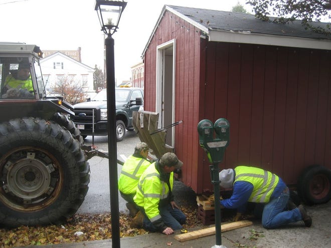 Greencastle borough workers Kevin Hunsberger, Jon Hess, Brian Maynard and Mike Lehman helped usher in the season by delivering and setting up the Holiday House in Center Square Monday morning. It will be the site for information and tickets during the Heritage Christmas celebration on Friday evenings, Dec. 6 and 13. SHAWN HARDY/ECHO PILOT