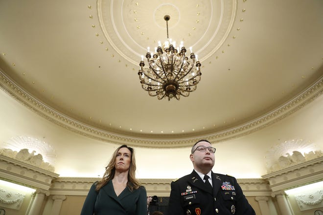 Jennifer Williams, an aide to Vice President Mike Pence, and National Security Council aide Lt. Col. Alexander Vindman stand as they take a break in hearing before the House Intelligence Committee on Capitol Hill in Washington Tuesday. [ANDREW HARNIK/ASSOCIATED PRESS]
