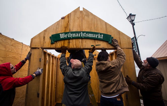 Volunteers help raise a hut as they set up the German Christmas Market at the Lake Mohawk boardwalk Monday, November 18, 2019, in Sparta. [Photo by Daniel Freel/New Jersey Herald (NJH)]
