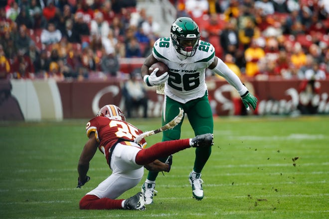 New York Jets running back Le'Veon Bell (26) moves past Washington Redskins strong safety Montae Nicholson (35) in the first half of an NFL football game, Sunday, Nov. 17, 2019, in Landover, Md. (AP Photo/Patrick Semansky)