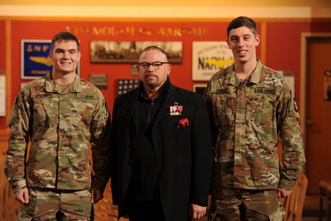 Brandon Graeff, left, and Brock Crippen, right, were congratulated on their ROTC national scholarships by retired Brig. Gen. Chris Lawson '88 following Monmouth College's Veterans Day ceremony. [PHOTO PROVIDED]