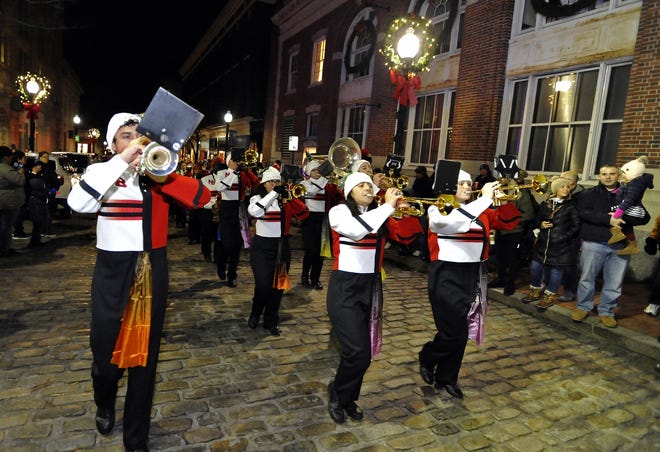In this file photo, members of the New Bedford High School Marching Band move up William Street before the lighting of the City of New Bedford's Official Christmas Tree. The parade and tree-lighting take place following the annual Downtown New Bedford Holiday Stroll. [DAVID W. OLIVEIRA/STANDARD-TIMES SPECIAL/SCMG]