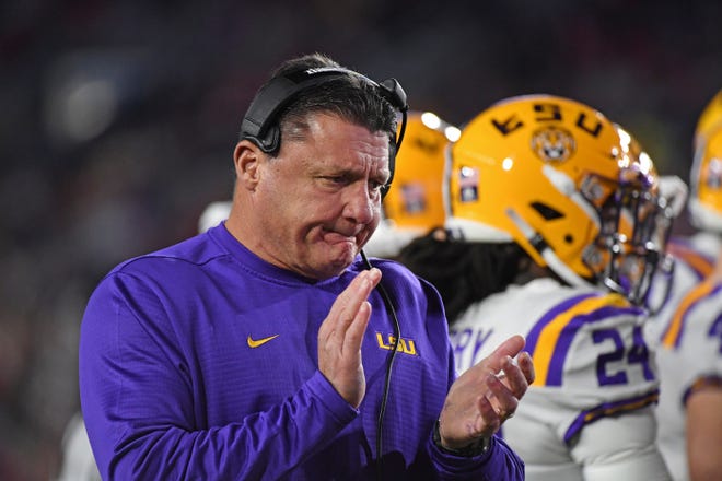LSU head coach Ed Orgeron claps during a timeout during the first half against Mississippi on Saturday in Oxford, Miss. [Thomas Graning/The Associated Press]