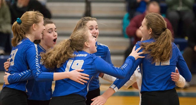 Lyman Memorial players celebrate after a successful kill during the Bulldogs’ 3-0 sweep over Immaculate in the Class S semifinals on Tuesday. [Sean McGirr/For The Bulletin]