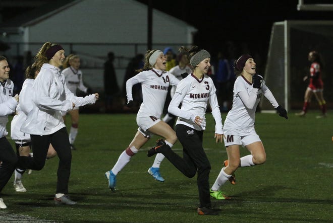 The Millis Mohawks race to meet their goalie after beating Amesbury 2-0 in the Division 4 state semifinals at Manning Field in Lynn on Wednesday. [Daily News and Wicked Local Staff Photo/Ann Ringwood]
