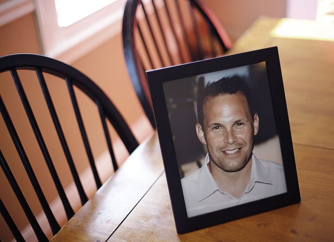 A frames family photo of Christopher on the kitchen table.

Kathy McCallum talks about the death of her husband Christopher last month at a Quincy social club at her Bridgewater home on Thursday March 7, 2019 Greg Derr/The Patriot Ledger