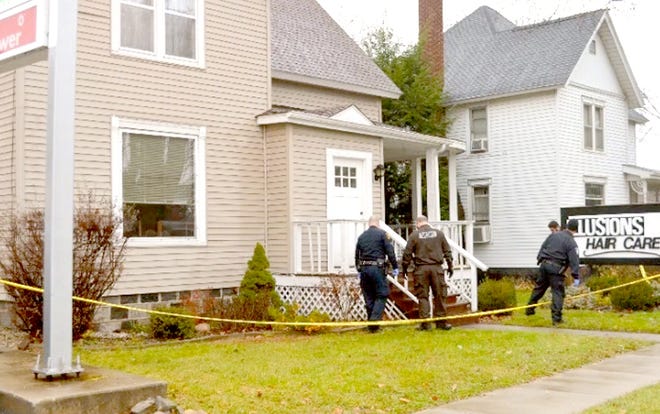 Authorities search the yard at 224 S. Blacksone in Colon after a 55-year old man was found dead there Thursday. A suspect has been arrested in the case, as investigation continues [Don Reod photo]