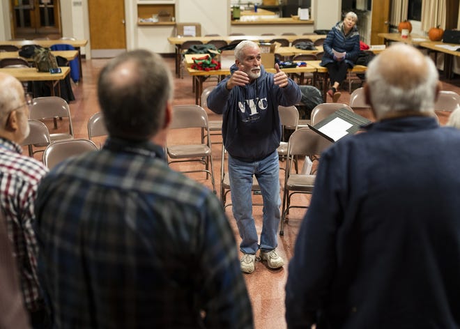 Mark Goodney directs the Worcester Men of Song as they rehearse Nov. 13 at Emanuel Lutheran Church. [T&G Staff/Ashley Green]