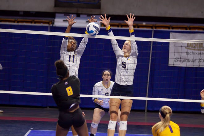 Gulf Coast’s Cassidi Gant (11) and Kilee Hudson (9) go up to block a shot during Thursday’s match against McHenry County in the national tournament in Charleston, W.V. [PHOTO BY LIZ KASEY]