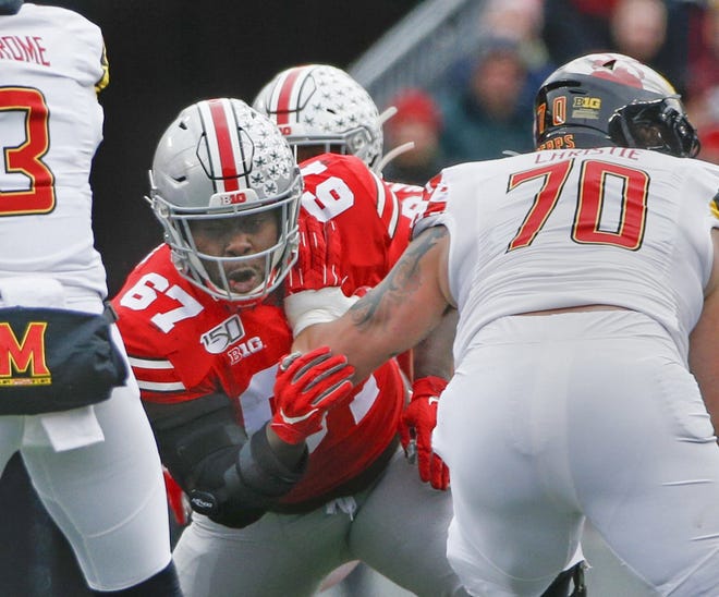Despite dominating opponents, Ohio State nose guard Robert Landers (67) thinks the defense “could do a lot better.” [Joshua A. Bickel/Dispatch]