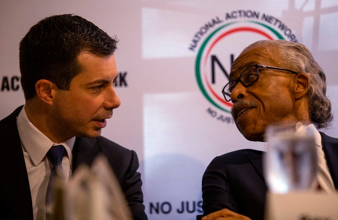 Pete Buttigieg, left, speaks with the Rev. Al Sharpton at a breakfast event on Thursday, November 21, 2019, in Atlanta. Buttigieg, along with Cory Booker, Amy Klobuchar, Andrew Yang and Tom Steyer, all presidential hopefuls, spoke at the event hosted by the Sharpton's National Action Network. (AP Photo/ Ron Harris)