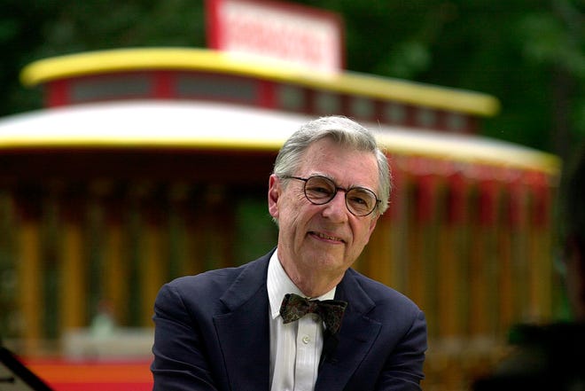 This July 12, 2000 file photo shows Fred Rogers being interviewed in front of the Mister Roger's Neighborhood Trolley attraction at Idlewild Park, in Ligonier, Pa. (Associated Press / Gene J. Puskar)