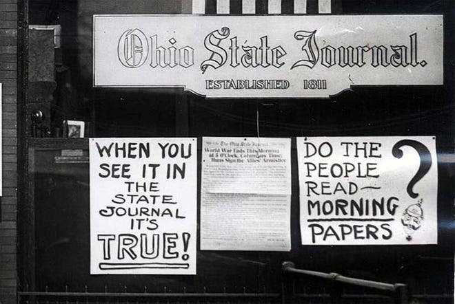 The front window of the Ohio State Journal newspaper in Columbus on Armistice Day, Nov. 11, 1918. [Walter D. Nice]