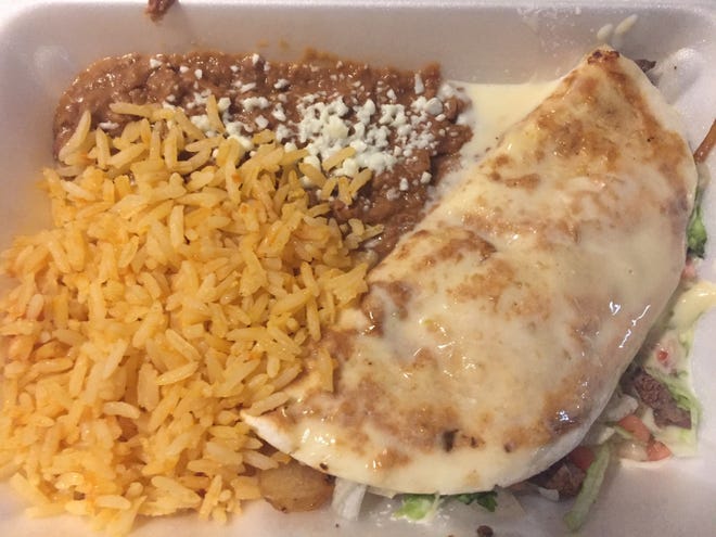 The Cheese Steak - a cheese quesadilla filled with steak grilled onion, lettuce, pico and smothered in cheese - served with rice and beans at Taqueria El Paisa. [Dan Naumovich photo]