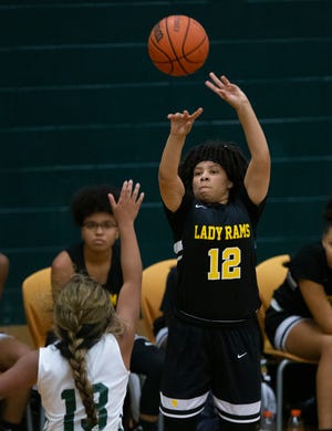 Rutherford’s Alexis McCray puts up a shot against the Dolphins during a game Thursday night. [MIKE FENDER/FOR THE NEWS HERALD]