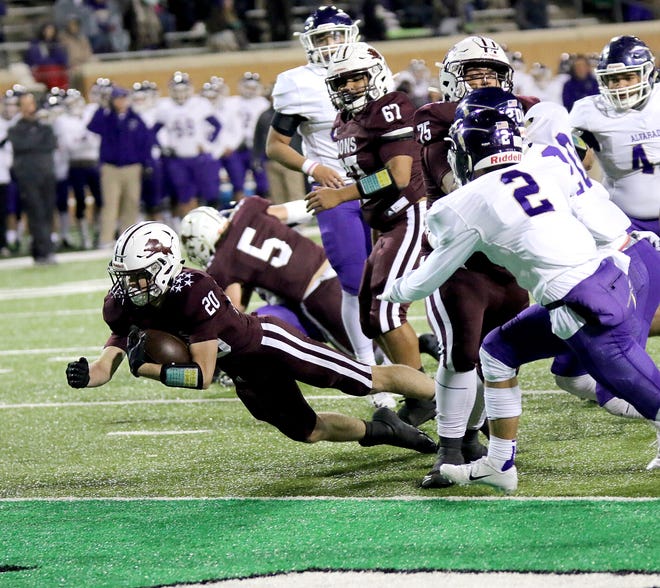 Reece Rodgers (20), who rushed for 149 yards, dives into the end zone for one of his three touchdowns in Brownwood's 37-35 area round playoff victory over Alvarado Friday night in Denton. [Photo by Derrick Stuckly]