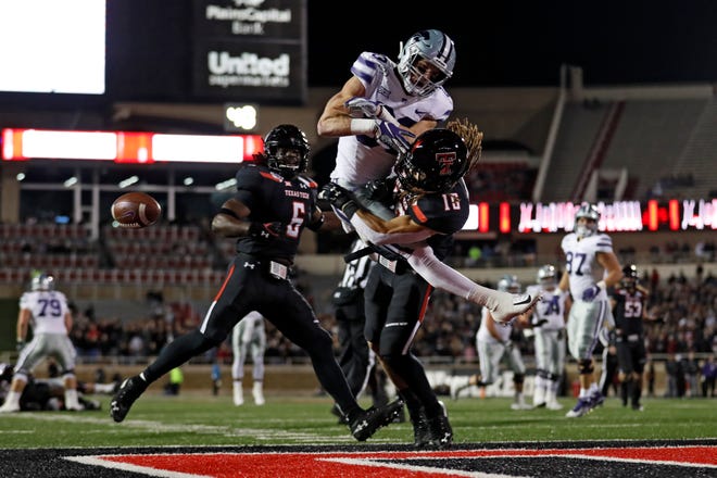 Texas Tech's Thomas Leggett (16) tackles Kansas State's Dalton Schoen (83) as he misses the pass during the first half of an NCAA college football game Saturday, Nov. 23, 2019, in Lubbock, Texas. [Brad Tollefson/A-J Media]