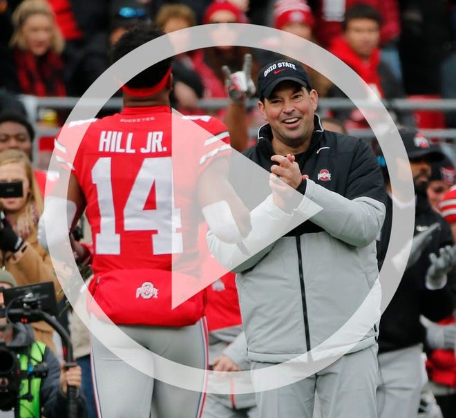 In this file photo Ohio State Buckeyes head coach Ryan Day applauds wide receiver K.J. Hill Jr. (14) as part of Senior Day festivities prior to the NCAA football game against the Penn State Nittany Lions at Ohio Stadium in Columbus on Saturday, Nov. 23, 2019.