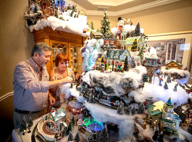 Ben Melchiorre and his wife, Becky, have created an impressive Christmas-themed village with trains, ski lifts, ice skaters and more in his dining room. [ERNST PETERS/THE LEDGER]