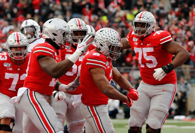 Ohio State running back J.K. Dobbins (2) celebrates his touchdown against Penn State with teammates during the first half of an NCAA college football game Saturday, Nov. 23, 2019, in Columbus, Ohio. (AP Photo/Jay LaPrete)