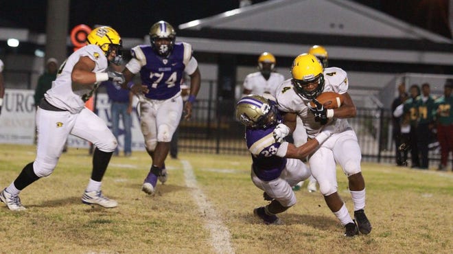 Ascension Catholic's Dorian Barber brings down Southern Lab's Dae'lon Hardy during the Kitten's 26-14 victory. Photo by Kyle Riviere.
