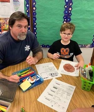 Jacob Heitz, left, spends time with his son Nye during Dad's Day on Tuesday, Nov. 19, 2019, at Empire Elementary School in Freeport. [JANE LETHLEAN/THE JOURNAL-STANDARD CORRESPONDENT]