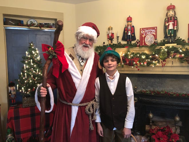 Attired in an 1800’s style Santa outfit, Don Thoenig of Stillwater poses as “St. Nicholas,” along with Tommy Tosti, age 11, also of Stillwater, who dressed in period costume, as one of Santa’s elves. [Photo by Jennifer Jean Miller/New Jersey Herald (NJH)]
