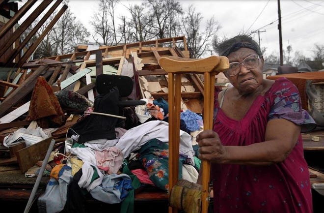 Lillie Mae Bogan sits by the wreckage of er home, destroyed by Hurricane Ivan when it hit the Panhandle in September 2004. [GREG LOVETT/ THE PALM BEACH POST]